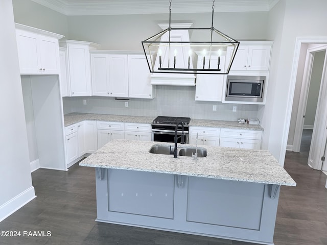 kitchen with white cabinets, decorative light fixtures, ornamental molding, and stainless steel appliances