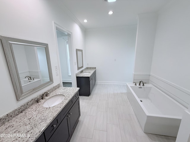 bathroom featuring crown molding, a bathtub, and vanity