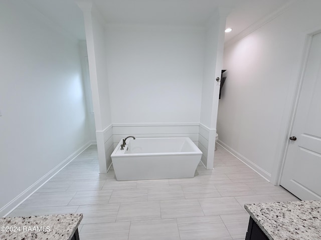 bathroom featuring crown molding, vanity, a bath, and toilet