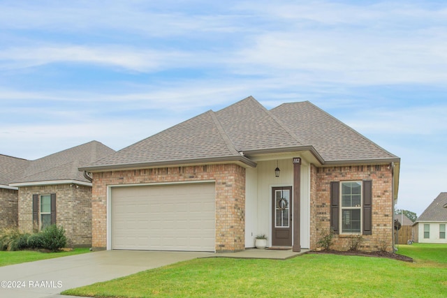 view of front of house with a front yard and a garage