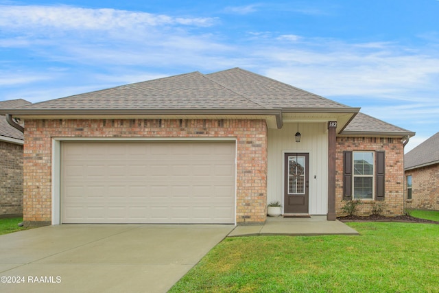 view of front of home featuring a front yard and a garage