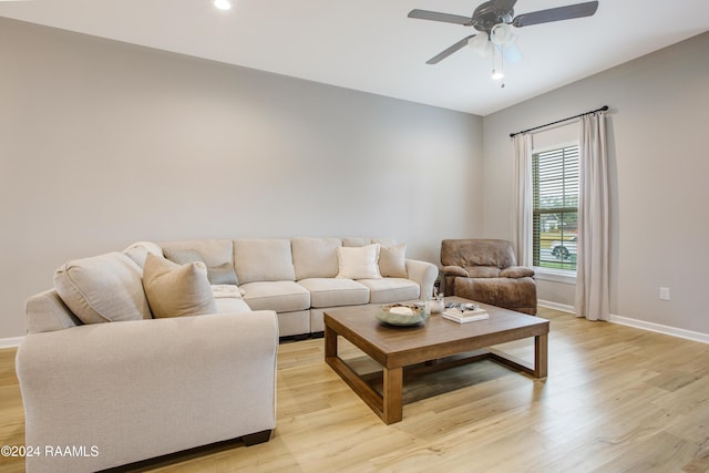 living room featuring light hardwood / wood-style floors and ceiling fan