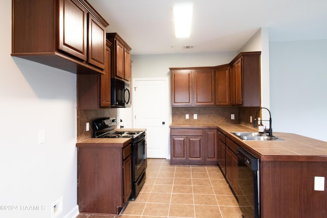 kitchen with decorative backsplash, light tile patterned floors, sink, and black appliances