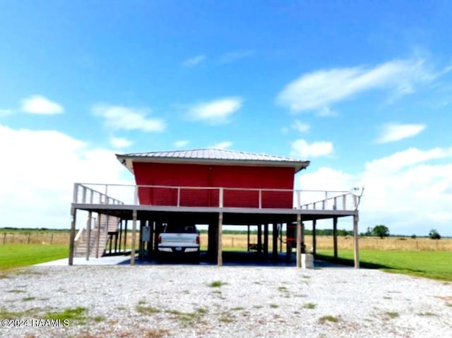 view of parking / parking lot featuring a rural view and a carport