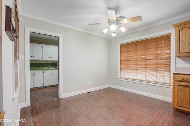 unfurnished dining area featuring ceiling fan and crown molding