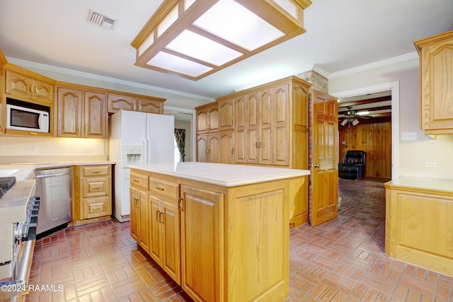 kitchen featuring ceiling fan, a center island, stainless steel appliances, parquet flooring, and ornamental molding