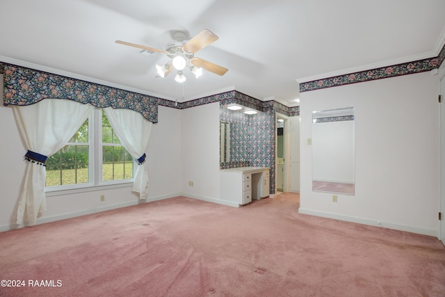 carpeted empty room with ceiling fan and ornamental molding