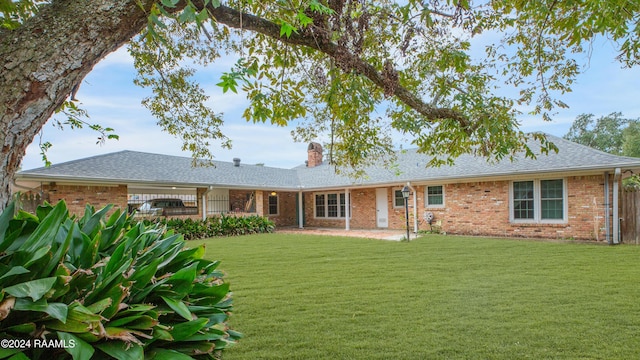 rear view of property featuring a yard