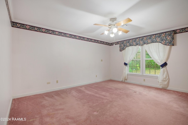 spare room featuring ceiling fan, carpet floors, and ornamental molding