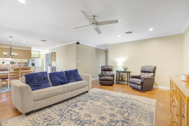 tiled living room featuring a textured ceiling, ceiling fan with notable chandelier, and ornamental molding