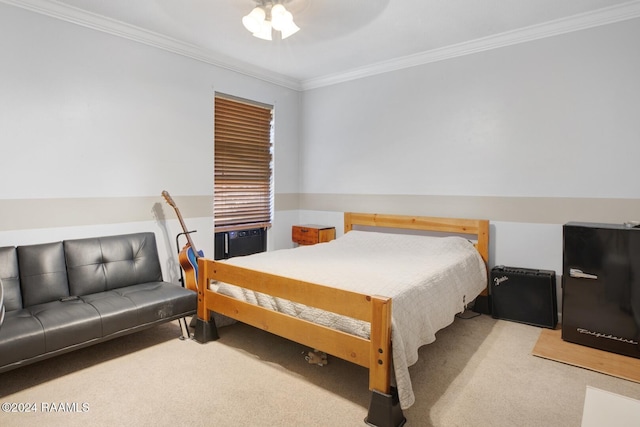 carpeted bedroom featuring ceiling fan and crown molding