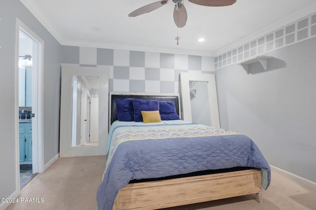 bedroom featuring ceiling fan, light colored carpet, ornamental molding, and connected bathroom