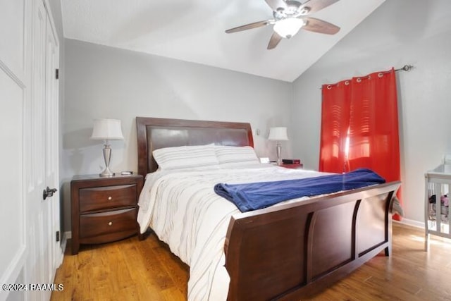 bedroom with lofted ceiling, ceiling fan, and wood-type flooring