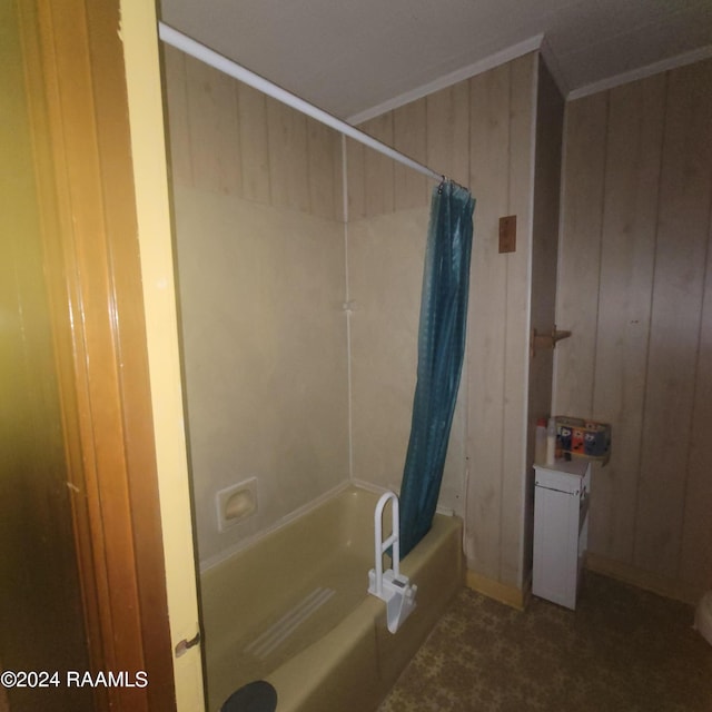 bathroom with wood walls and shower / tub combo with curtain