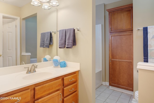 bathroom with toilet, vanity, and tile patterned floors