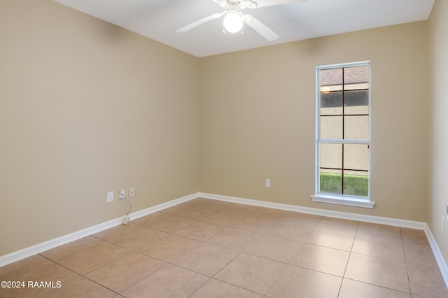 tiled empty room featuring a wealth of natural light and ceiling fan