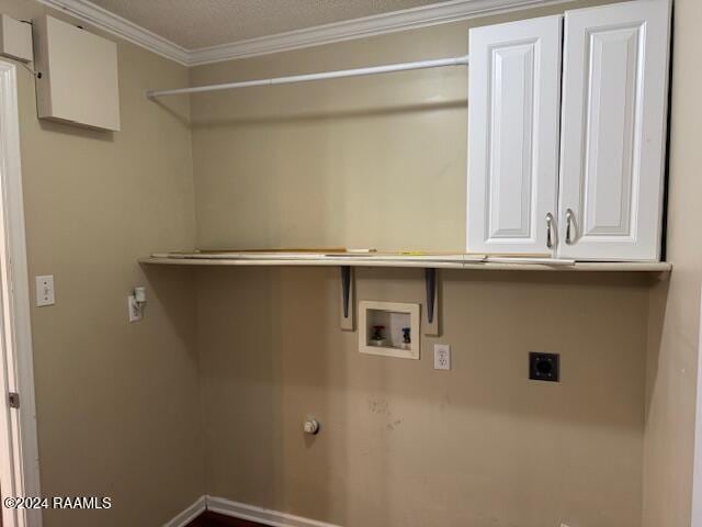 clothes washing area with electric dryer hookup, cabinets, crown molding, washer hookup, and a textured ceiling