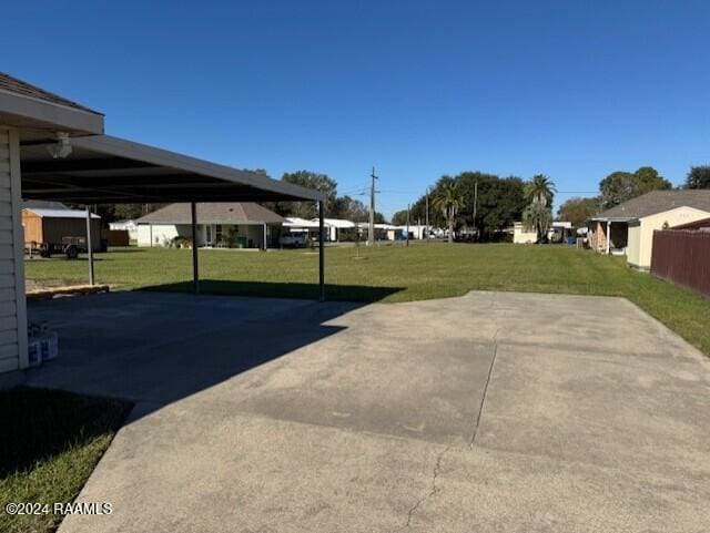 view of vehicle parking featuring a lawn