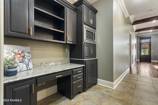 kitchen featuring light stone countertops, stainless steel microwave, beamed ceiling, crown molding, and light wood-type flooring