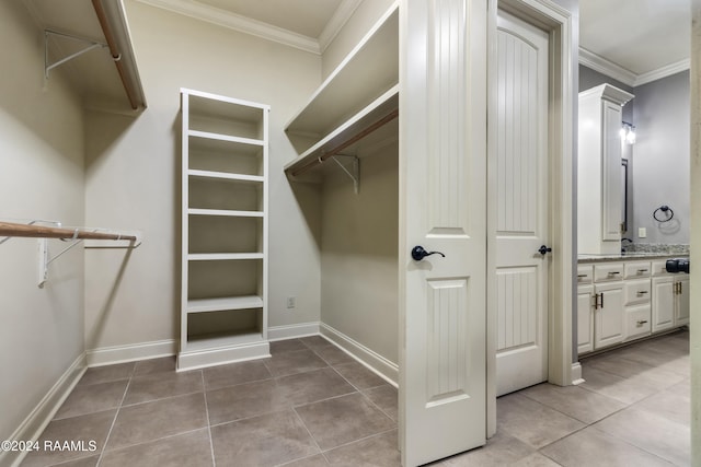 spacious closet with light tile patterned floors