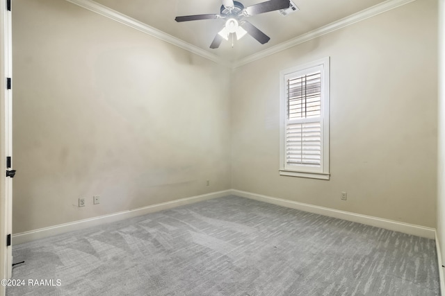 carpeted spare room featuring ceiling fan and ornamental molding