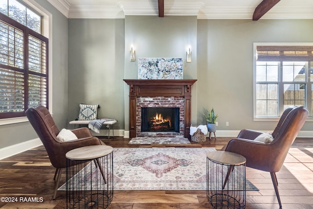 living room featuring a fireplace, beam ceiling, hardwood / wood-style flooring, and ornamental molding