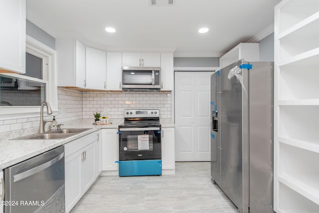 kitchen with sink, white cabinetry, and stainless steel appliances