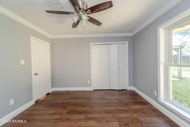 unfurnished bedroom featuring a closet, ceiling fan, crown molding, and dark wood-type flooring