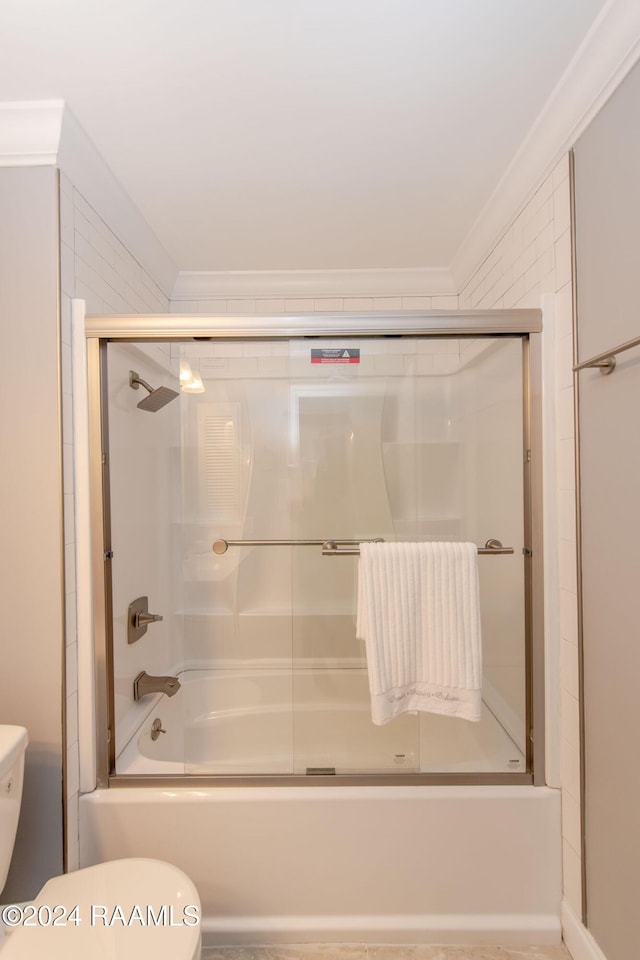 bathroom with shower / bath combination with glass door, toilet, and crown molding