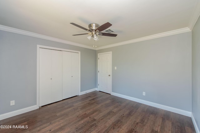 unfurnished bedroom with ceiling fan, dark hardwood / wood-style floors, crown molding, and a closet