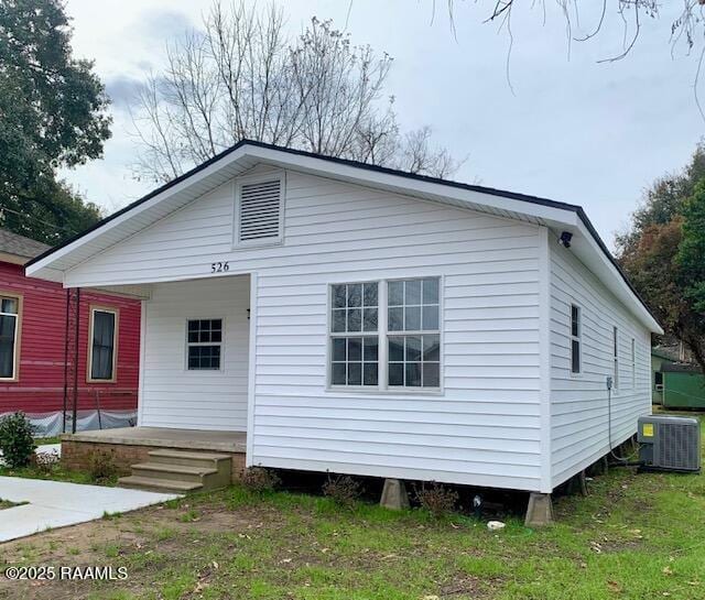 view of front of property with a porch and cooling unit