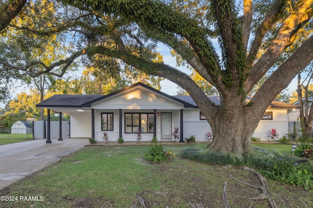 view of front of house with a carport, covered porch, and a front yard