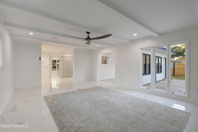 spare room featuring ceiling fan and beam ceiling