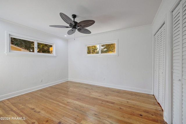 unfurnished bedroom with light hardwood / wood-style floors, ceiling fan, and ornamental molding