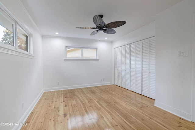 unfurnished bedroom featuring a closet, ceiling fan, light hardwood / wood-style flooring, and crown molding