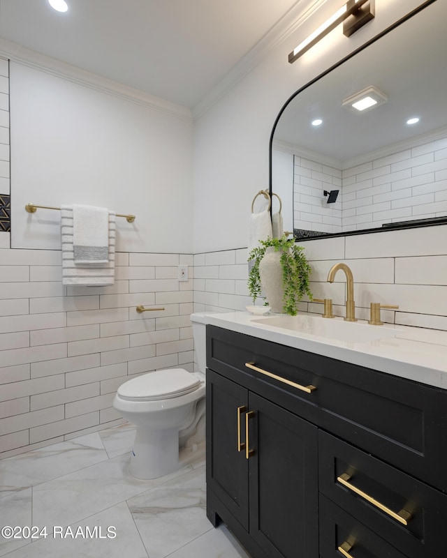 bathroom with crown molding, vanity, tile walls, and toilet