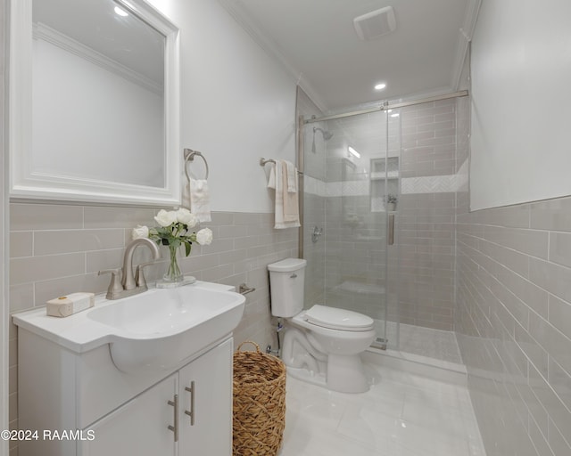 bathroom with toilet, a shower with door, vanity, tile walls, and ornamental molding