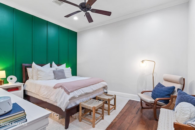 bedroom featuring ceiling fan, dark hardwood / wood-style floors, and ornamental molding