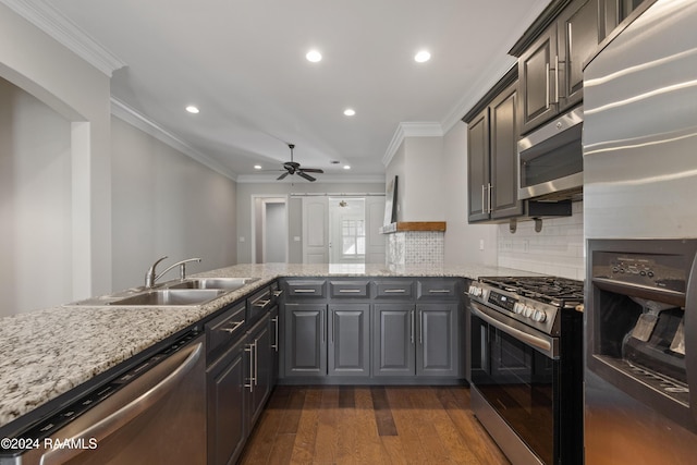 kitchen featuring sink, stainless steel appliances, dark hardwood / wood-style flooring, backsplash, and crown molding