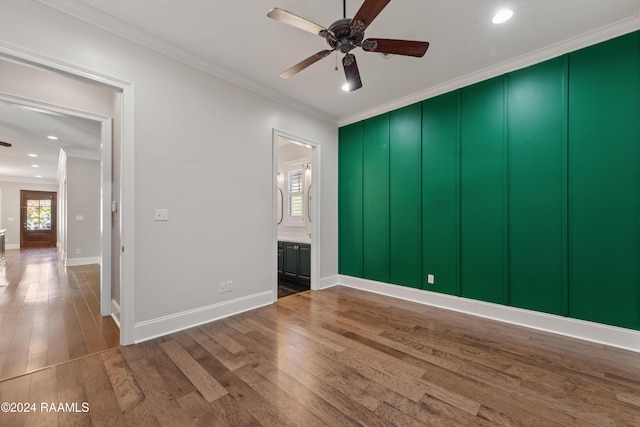 unfurnished room with hardwood / wood-style flooring, ceiling fan, and ornamental molding