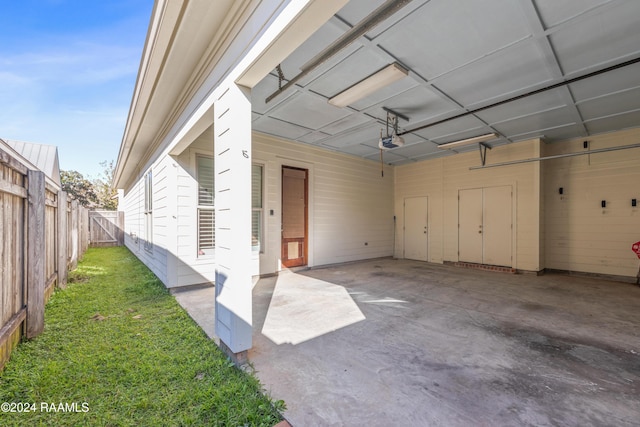 garage with a yard and a garage door opener