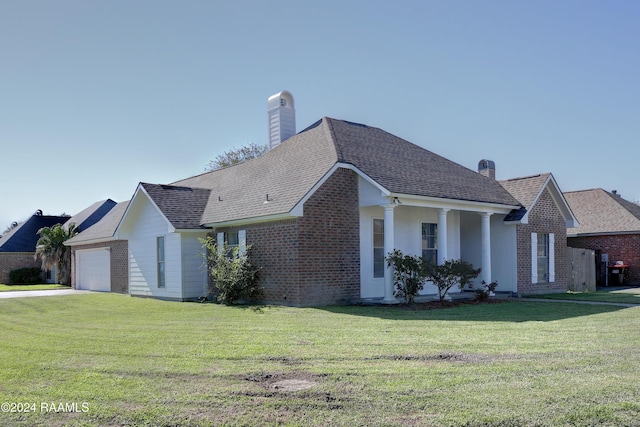 view of home's exterior with a garage and a lawn