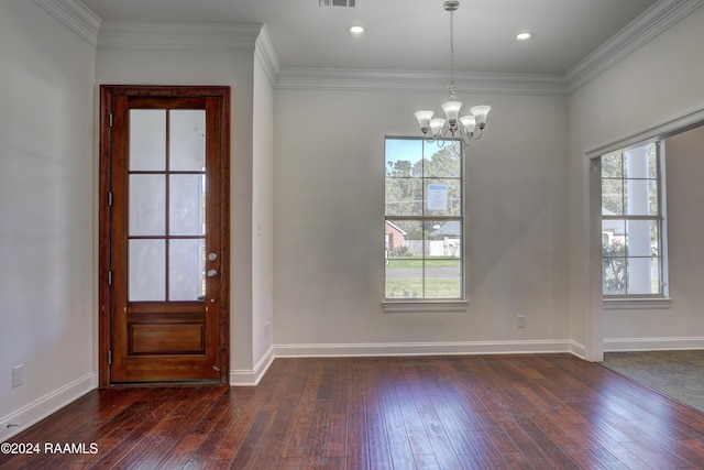 foyer with dark hardwood / wood-style floors, a wealth of natural light, and a notable chandelier