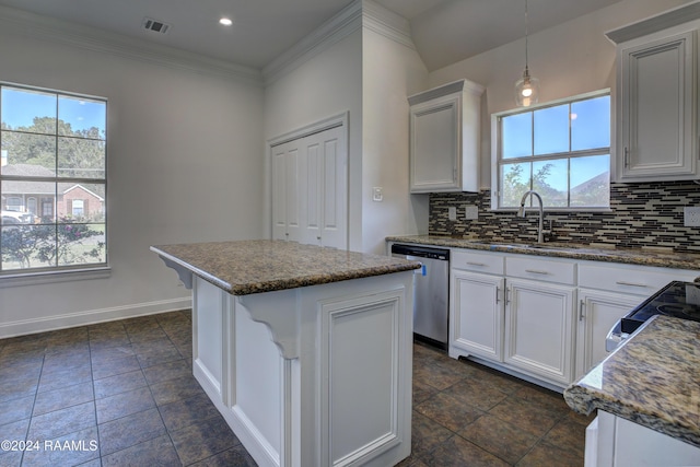 kitchen featuring dishwasher, white cabinets, sink, decorative light fixtures, and a kitchen island