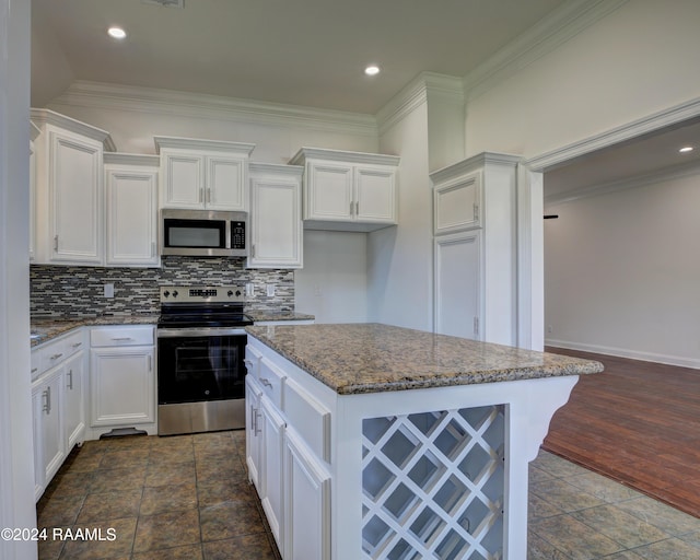 kitchen featuring appliances with stainless steel finishes, white cabinetry, dark wood-type flooring, and dark stone countertops