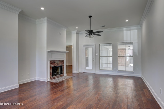 unfurnished living room featuring ceiling fan, dark hardwood / wood-style flooring, ornamental molding, and a brick fireplace