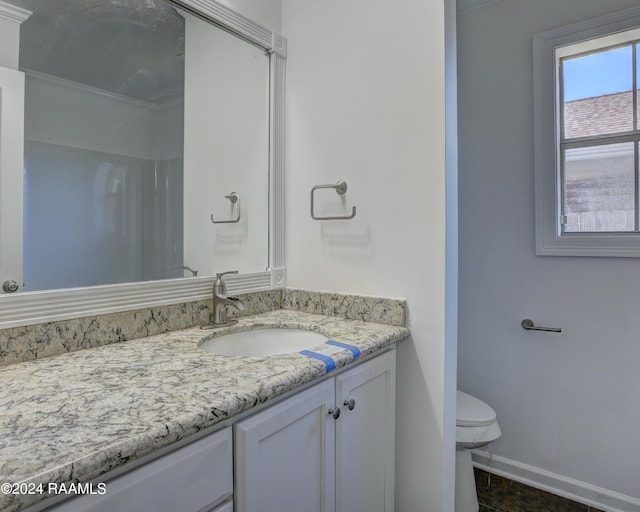 bathroom featuring vanity and toilet