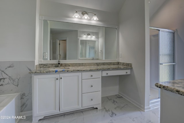 bathroom with vanity, separate shower and tub, and tile walls