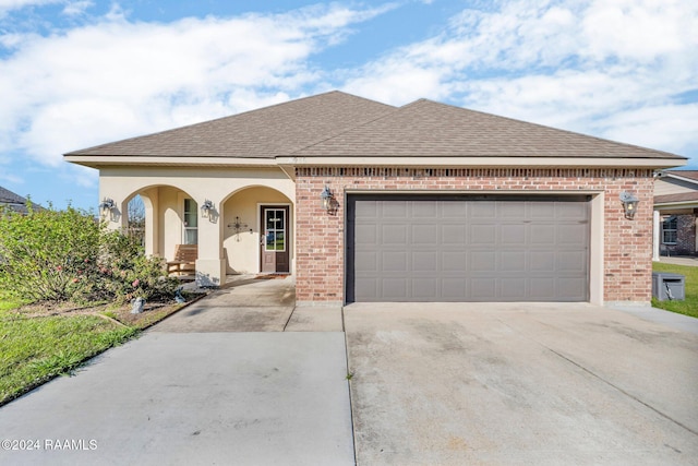 view of front of property with a garage and covered porch