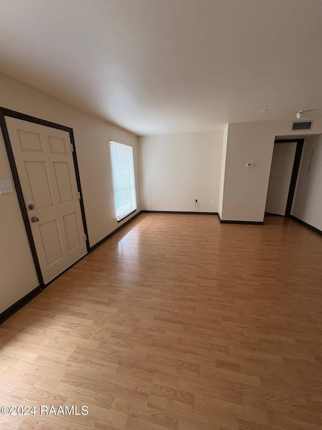701 S College Rd Unit 307, Lafayette, LA 70503 - spare room featuring light wood-type flooring and baseboards